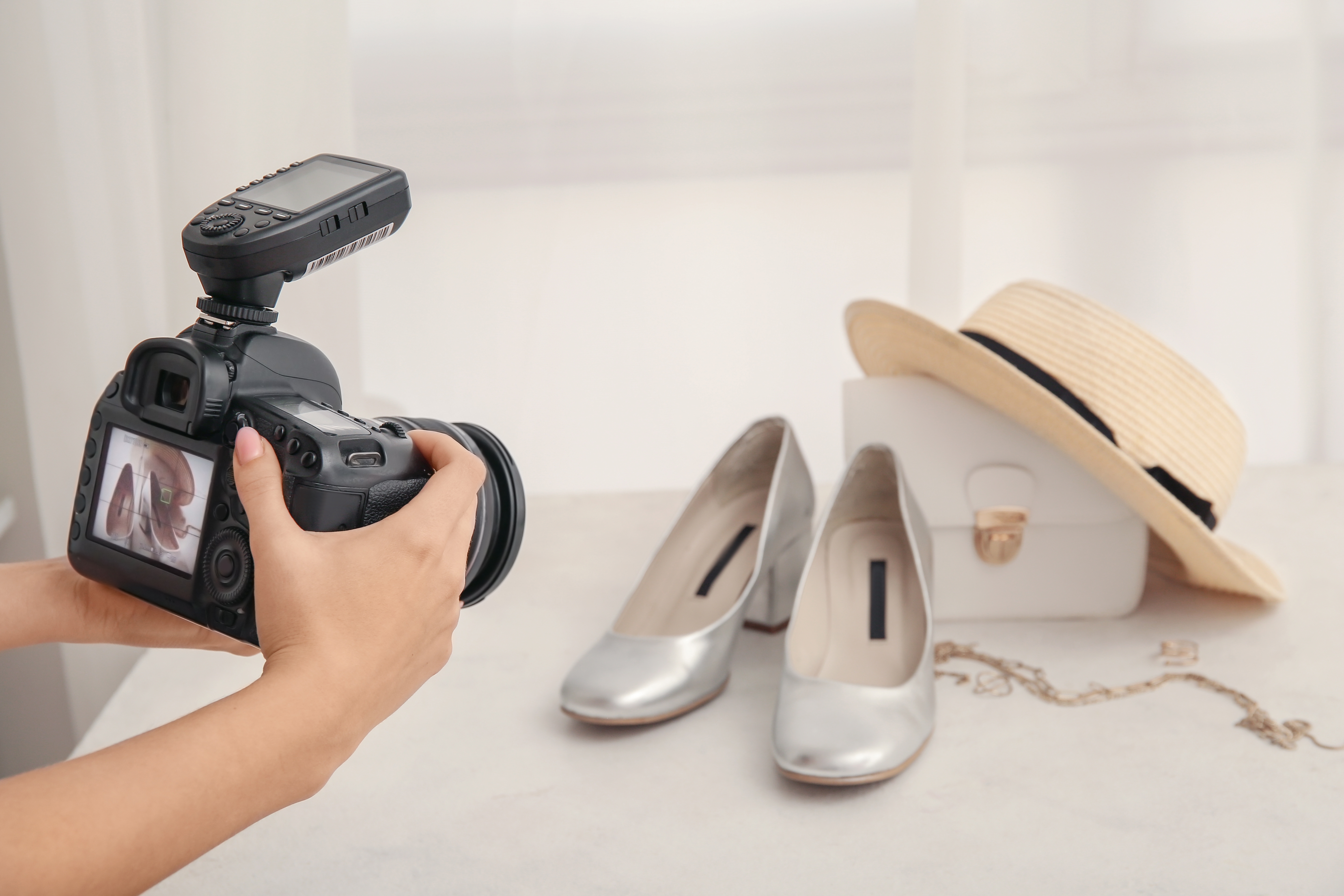 Female,Photographer,Taking,Photo,Of,Fashionable,Shoes,,Purse,And,Jewellery